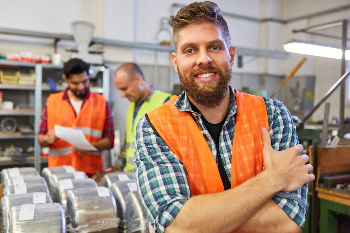 Happy Warehouse Worker in the Material Warehouse of the Factory